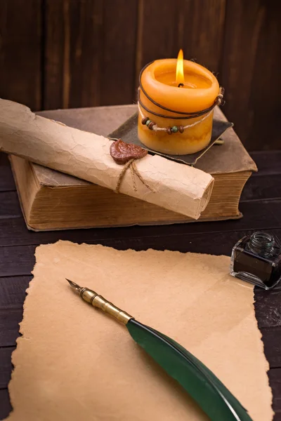 Old paper candle and quill pen