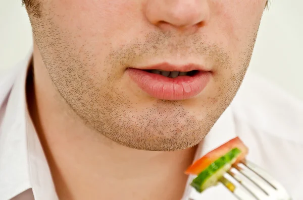 Man eating salad. Close up