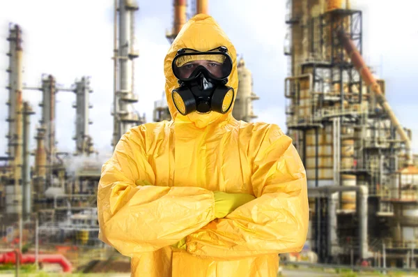 Man in chemical protective suit over factory