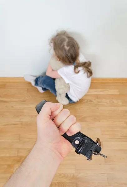 Little girl crying in the corner. Domestic violence concept.