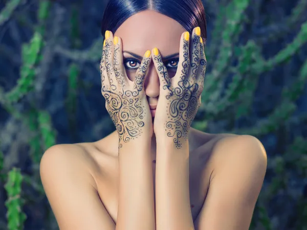 Lady with painted hands mehendi