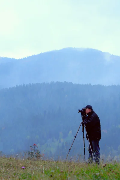 Photographer shoting multicolored hills