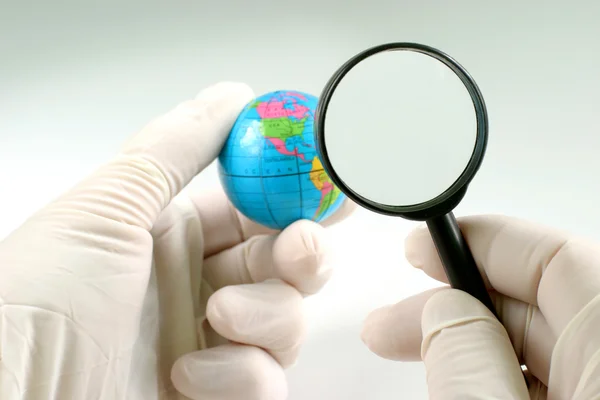 Earth globe & human hand