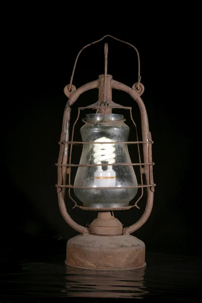 The old dirty kerosene lamp with modern bulb