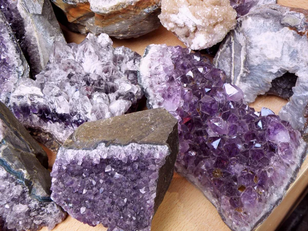 Shiny Amethyst Crystals on a Wooden Table