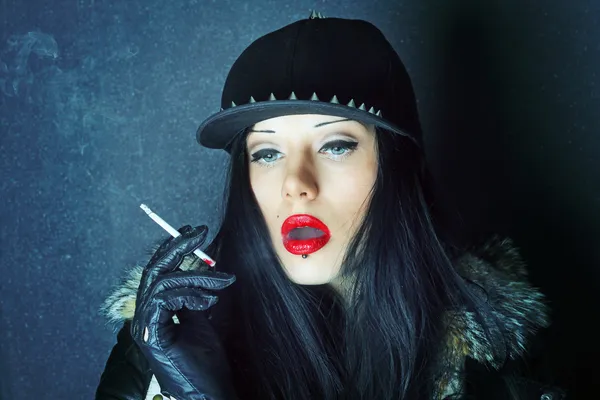 Red lipstick. Cigarette smoke. Girl smokes.
