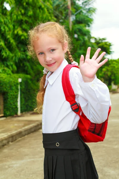 Young little girl preparing to walk to school