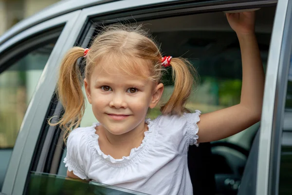 Little girl sitting in a car