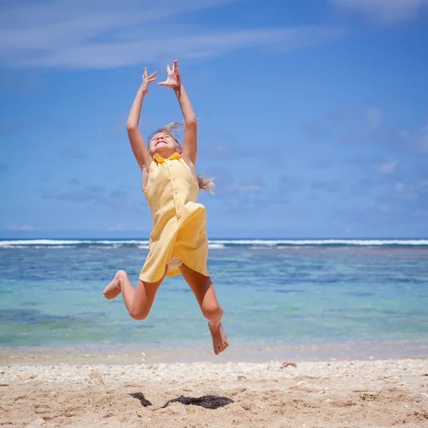 Flying jumping beach girl at blue sea shore in summer vacation i