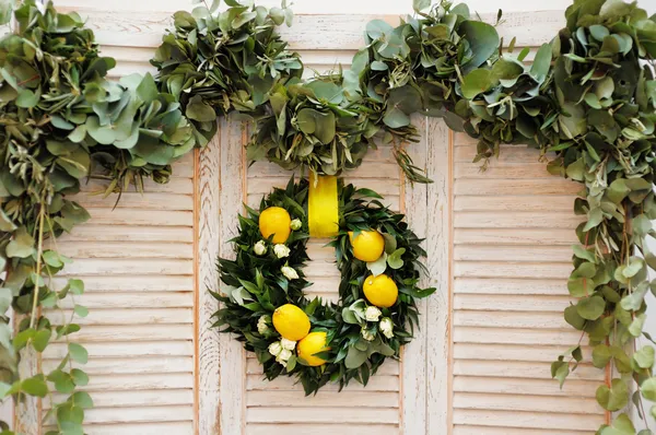 Wreath made of laurel leaves, roses and lemons