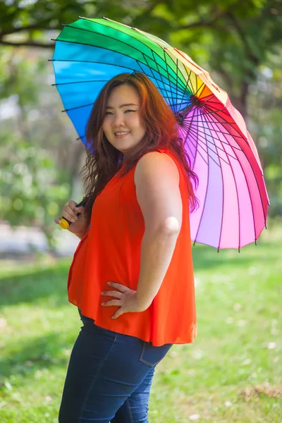 Happy fatty woman with umbrella