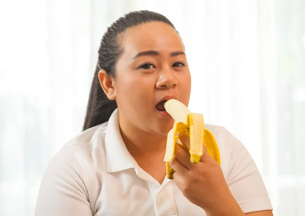 Fat woman with banana