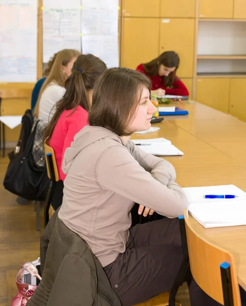 Young women at final  examination  with teacher