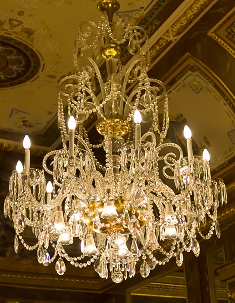 Chandelier hanging under a ceiling in a palace