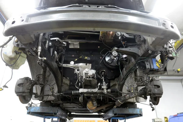 Car in garage with special equipment prepared for repair