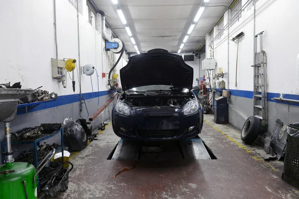 Car in garage with special equipment prepared for repair