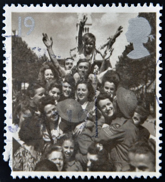 A stamp printed in Great Britain shows British Troops and French Civilians celebrating End of the Second World War