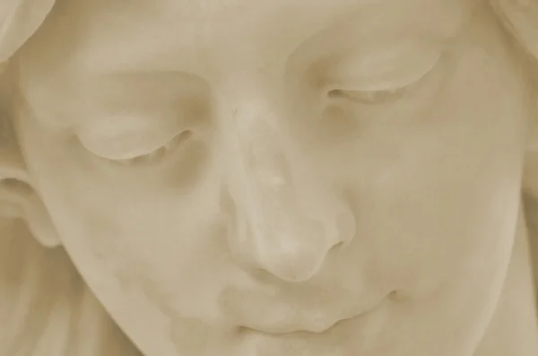 Detail of face of angel in cemetery