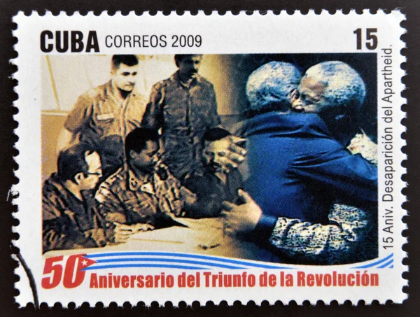 CUBA - CIRCA 2009: A stamp printed in cuba dedicated to 50 anniversary of the triumph of the revolution, shows anniversary of the demise of apartheid, embrace between Fidel and Mandela, circa 2009