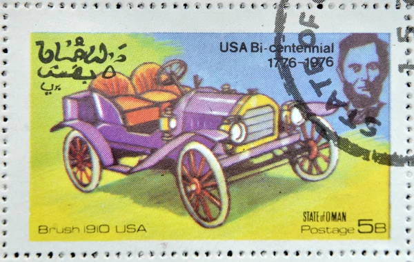 OMAN - CIRCA 1976: A stamp printed in State of Oman shows a american car, brush 1910 usa, circa 1976