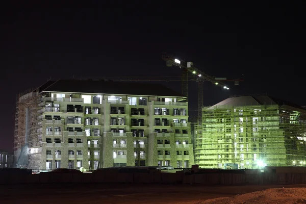 Apartment building construction at night. Dubai, United Arab Emirates