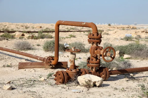 Rusty oil pipes in the desert of Bahrain. Middle East