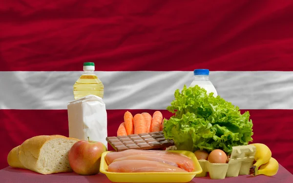 Basic food groceries in front of latvia national flag