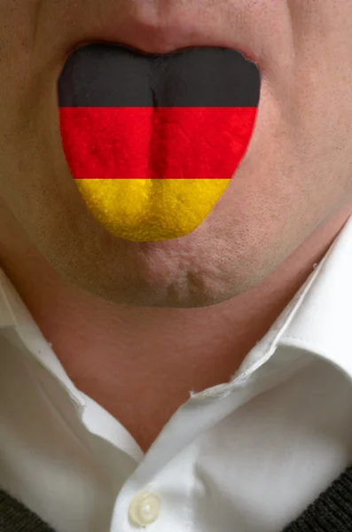 Man tongue painted in germany flag symbolizing to knowledge to s