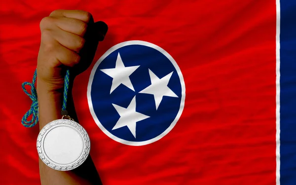 Silver medal for sport and flag of american state of tennessee