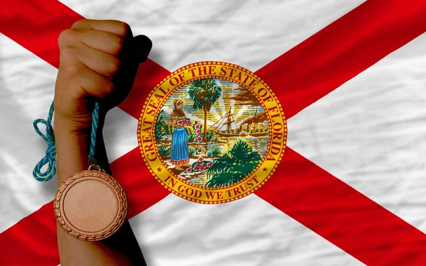 Bronze medal for sport and flag of american state of florida