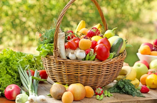Wicker basket is full with fresh organic fruits and vegetables
