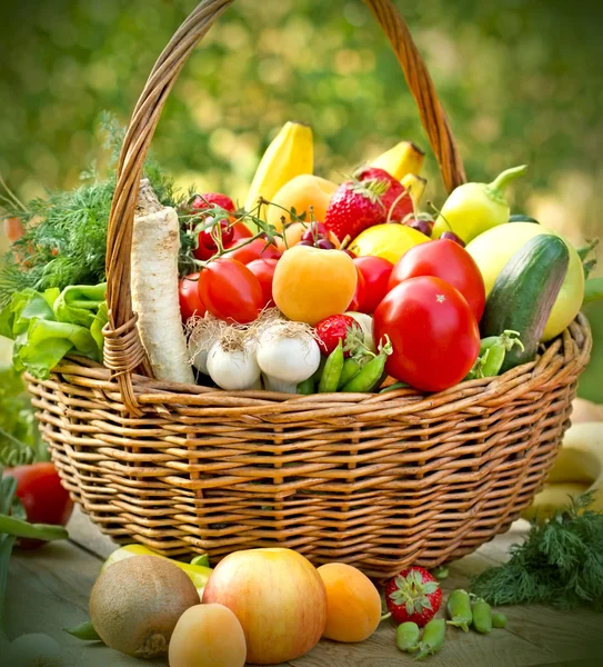 Wicker basket is full of fresh fruits and vegetables