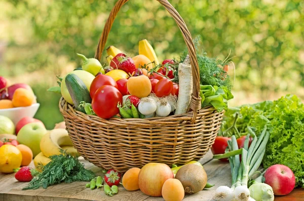 Wicker basket is full of fresh fruits and vegetables