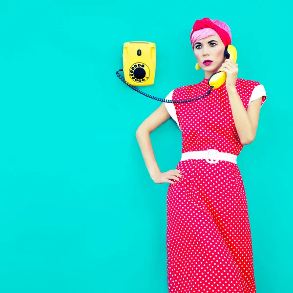 Retro fashion girl talking on a vintage telephone