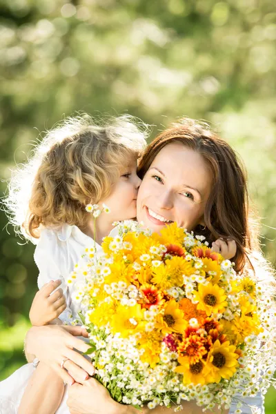 Woman and child with bouquet of flowers
