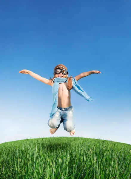 Happy kid jumping outdoors