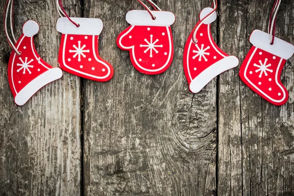 Red Christmas tree decorations on grunge wood