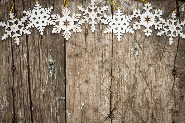 Snowflakes border on wood