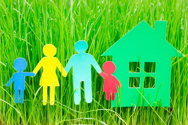 Paper family and house in grass