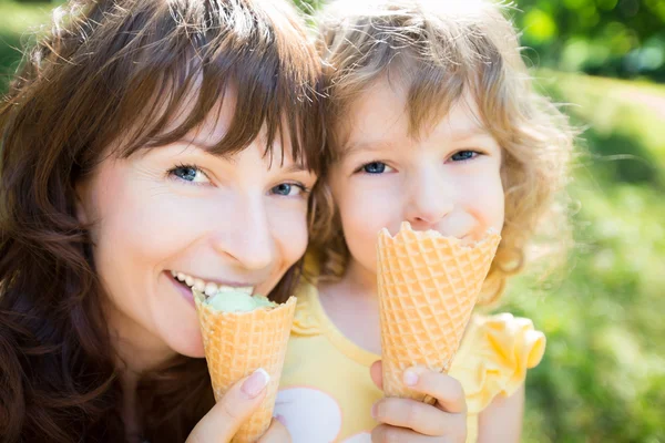 Happy child and mother eating ice cream