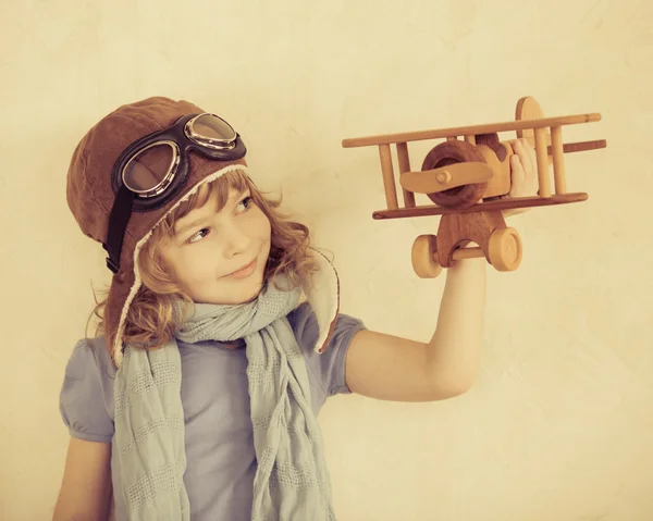 Happy kid playing with toy airplane