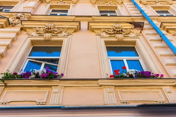 Flowers on the window sills of the old house in Arbat street of