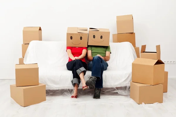 Couple in their new home with cardboard boxes