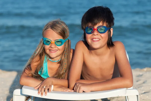 Kids with swimming goggles on the beach — Stock Photo #28320221