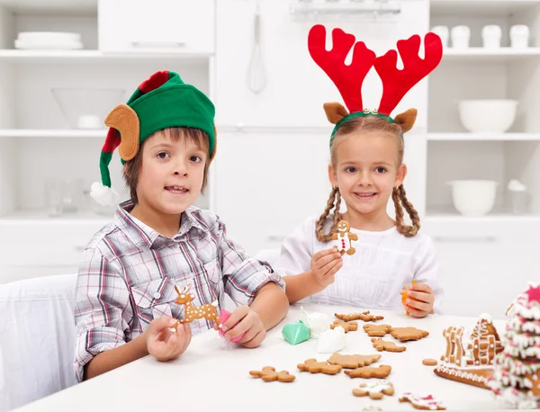 Kids decorating gingerbread christmas cookies