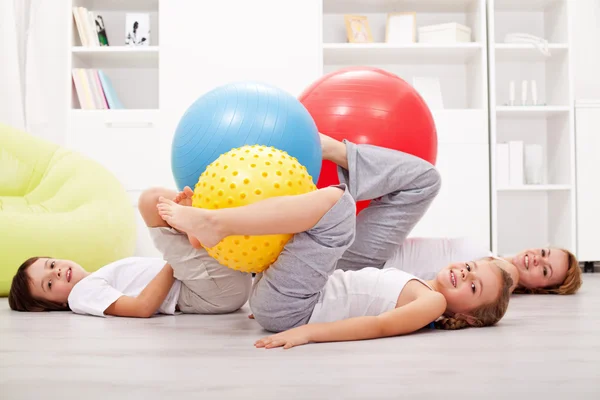 Family exercising with large gymnastic balls