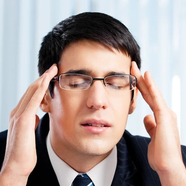 Thinking, tired or ill with headache businessman