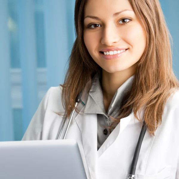 Cheerful female doctor with laptop