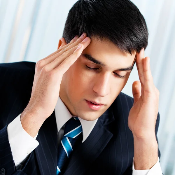 Thinking, tired or ill with headache businessman