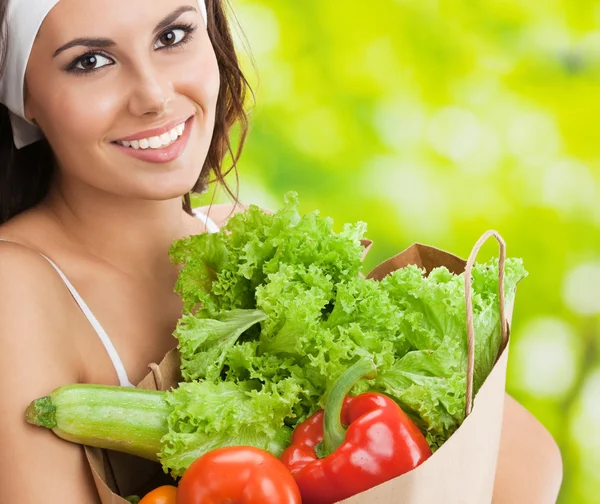 Woman in fitness wear with vegetarian food